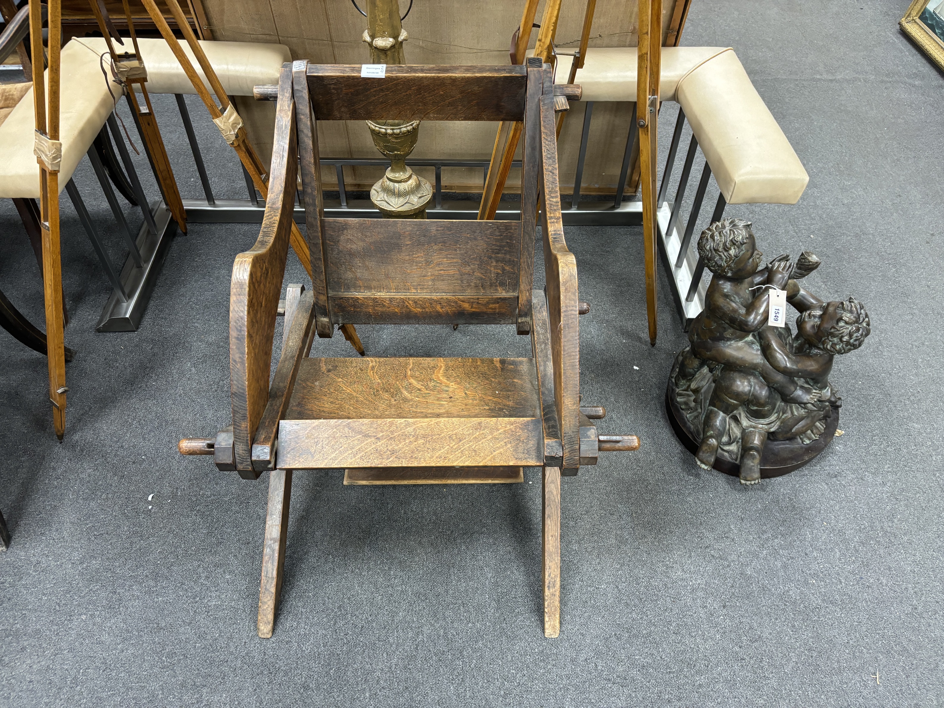 An oak Glastonbury chair, width 74cm, depth 64cm, height 78cm, Provenance- Brede Place, East Sussex, a former residence of the Frewen family from 1712-1936.